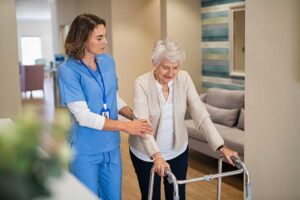 Older adults share a balanced meal at a bright assisted living dining table with water and fresh foods.